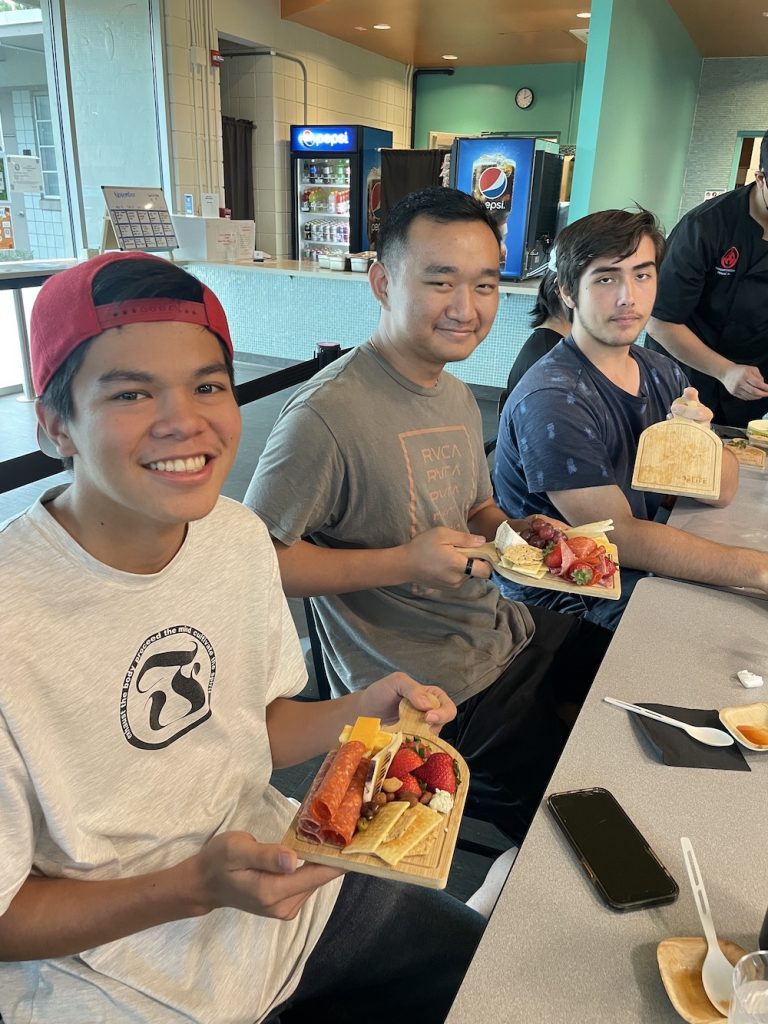 students participating in the build-a-charcuterie event in the cafeteria 